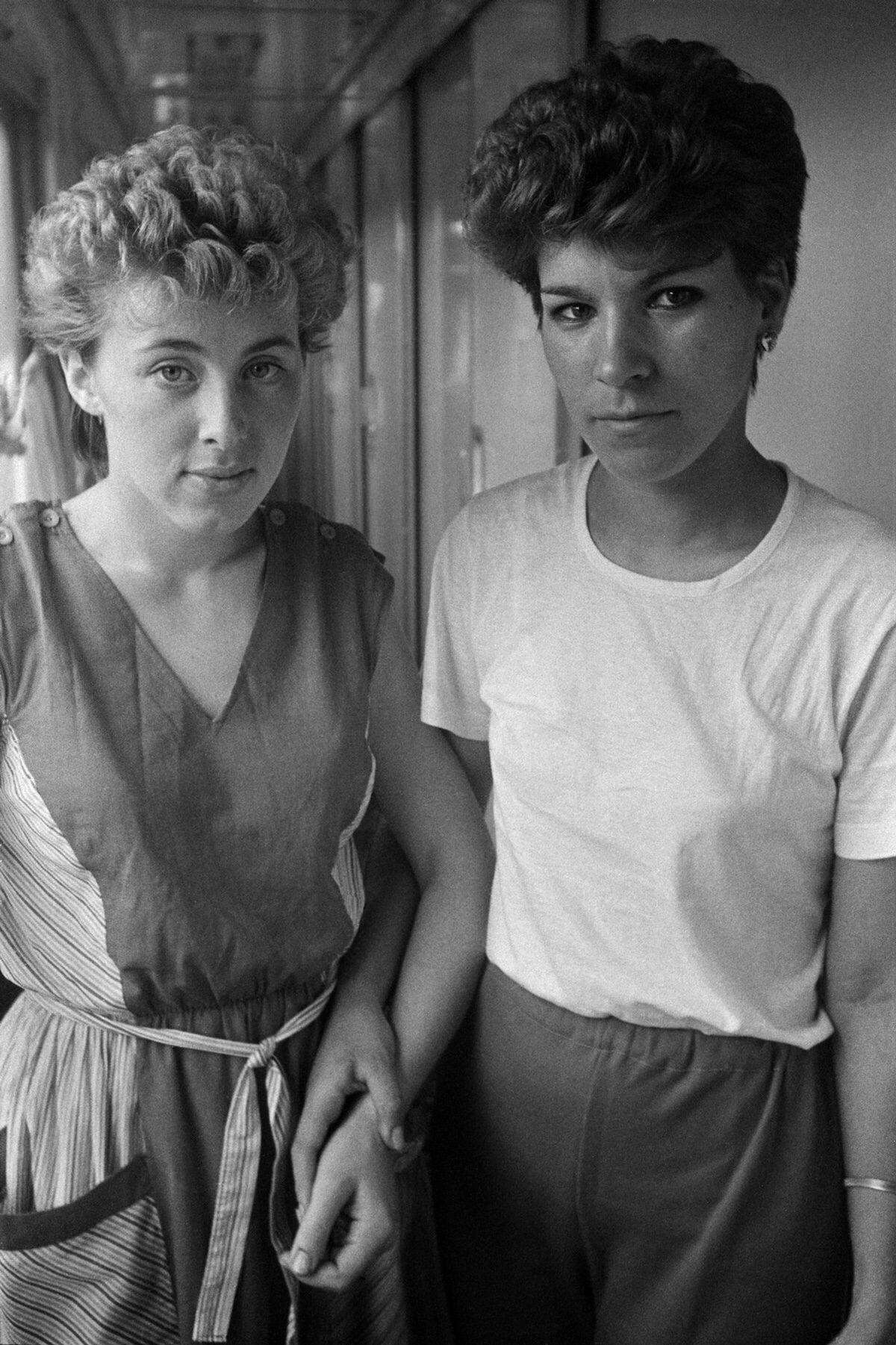 photograph of two women holding hands